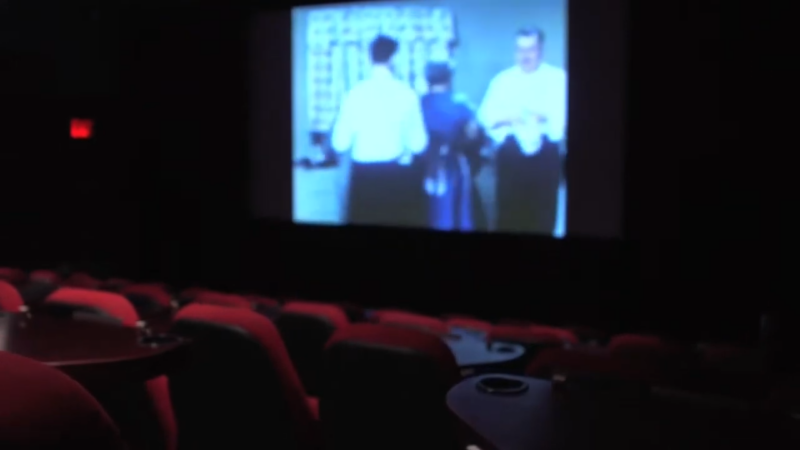 A View of Nitehawk Cinema in Williamsburg, with Empty Seats and A Vintage Film Playing on The Screen