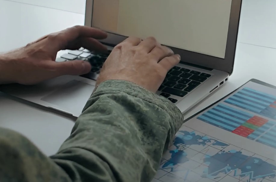 Military worker checks taxes on his laptop