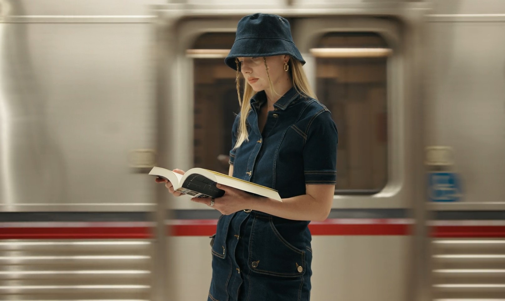 Girl reading a book in NYC subway