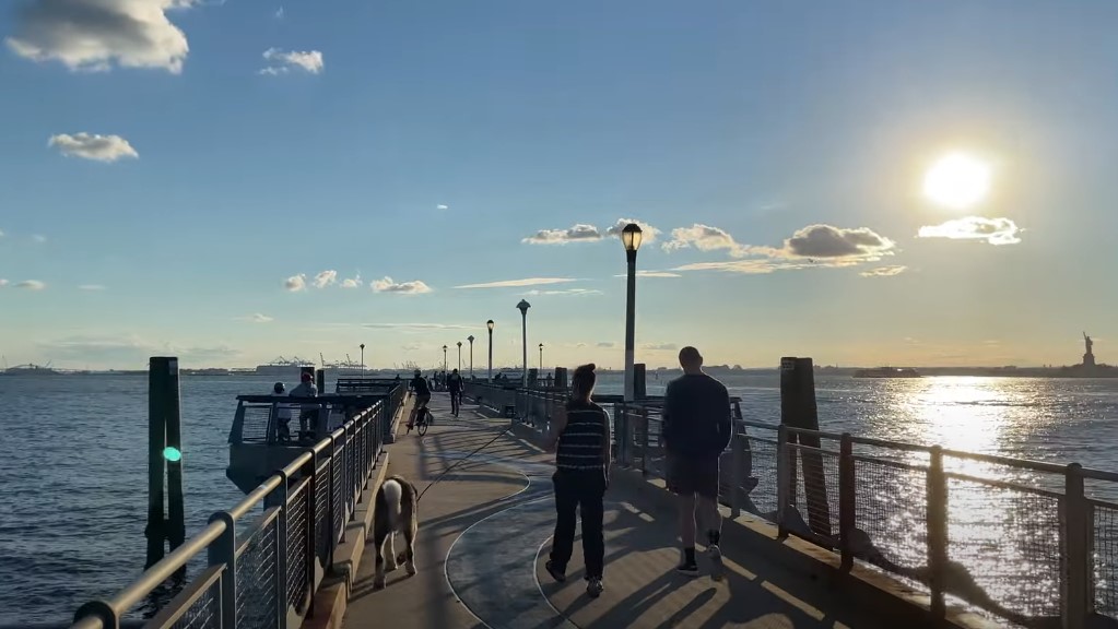 A couple walking with a dog at the Valentino Pier