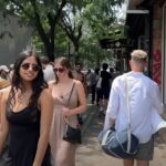 A bustling city street, filled with pedestrians of various ages and styles