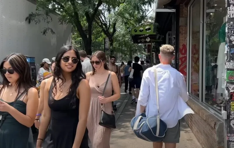 A bustling city street, filled with pedestrians of various ages and styles