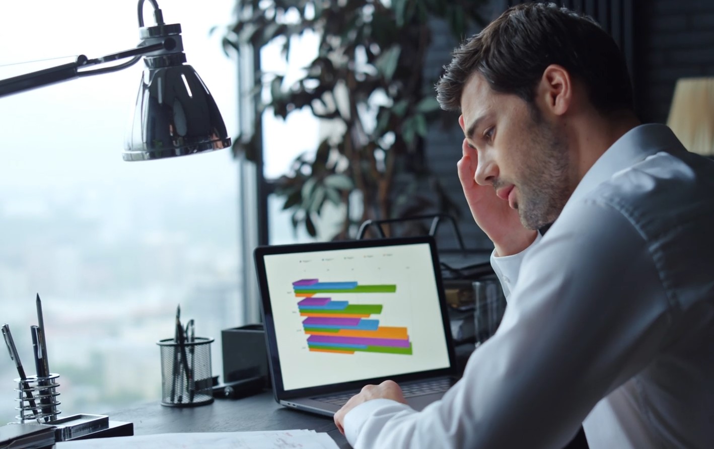 A man deeply engrossed in reviewing financial data