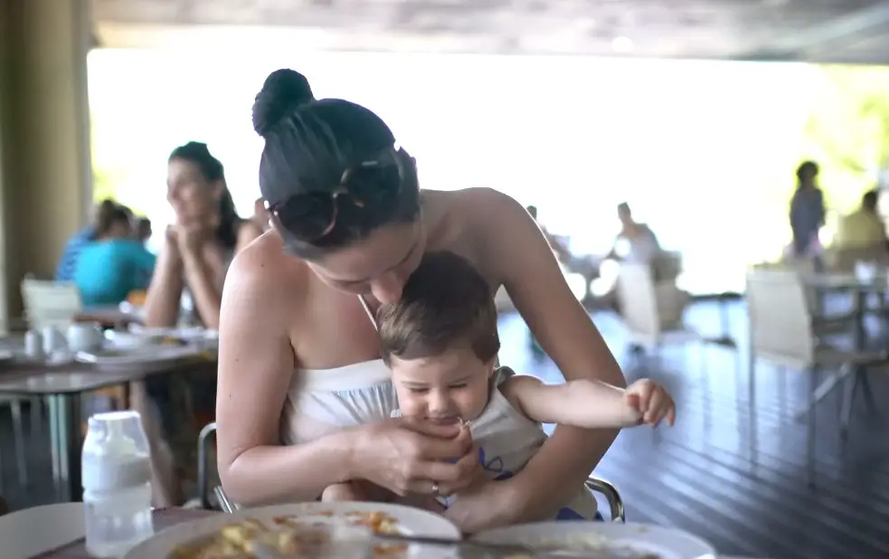 Mom feeds her baby in a restaurant