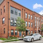 Modern brick townhouses line the street in Baltimore