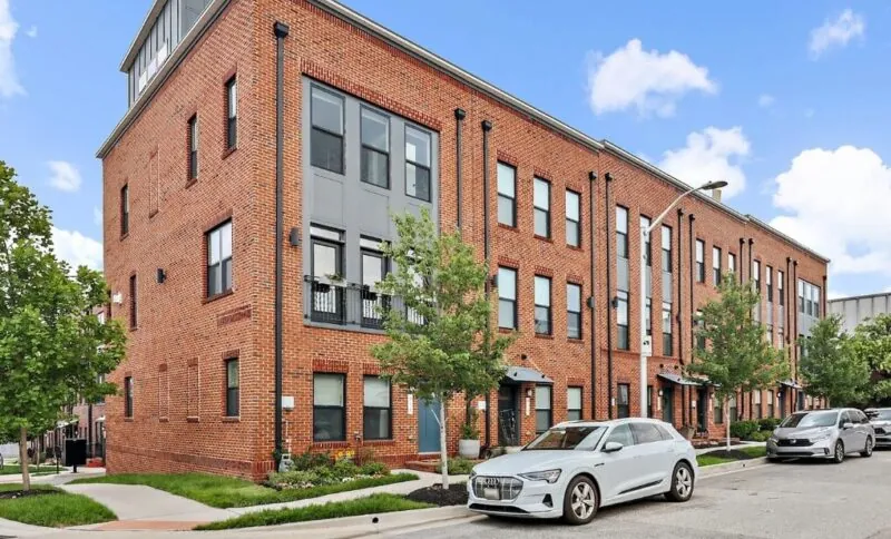 Modern brick townhouses line the street in Baltimore