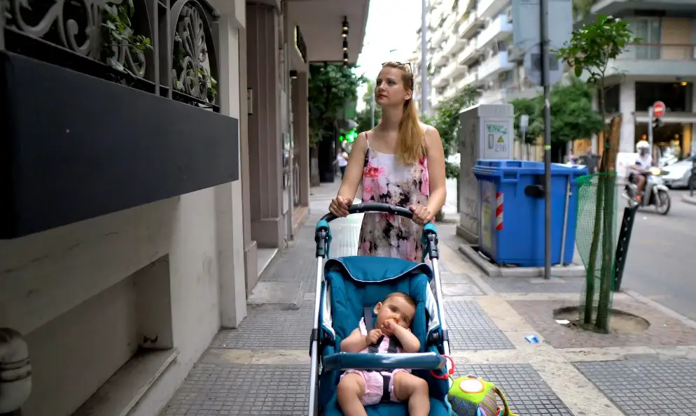 Mom strolling through NYC streets with a baby