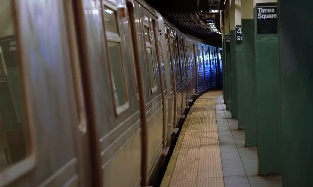 A New York City subway train sits at the Times Square station