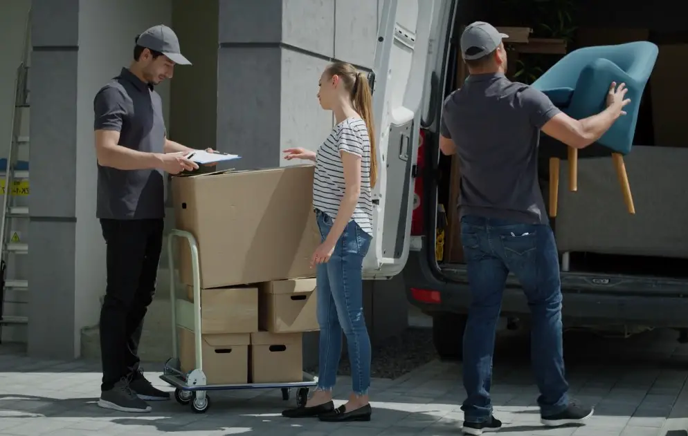 Professional movers loading a van with belongings