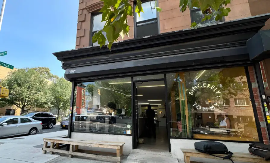 A charming storefront, "Sincerely Tommy," welcomes passersby on a sunny day