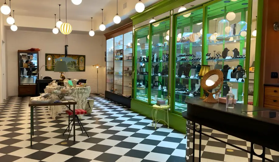 A charming shop, filled with exquisite jewelry displayed in green display cases