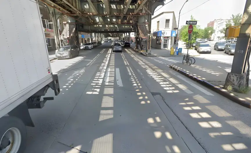 Urban street scene beneath a railway overpass