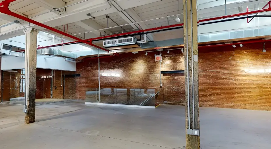 Exposed brick walls and high ceilings create a spacious, industrial feel